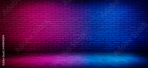 black brick wall background with neon lighting effect pink purple and blue. glowing lights on empty brick wall background
