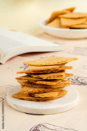 Kue semprong is an Indonesian traditional wafer snack made by clasping egg batter using an iron mold which is heated up on a charcoal stove. The taste of this cake is not too sweet and will be crunch