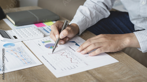 Asian businessmen are analyzing graphs, Financial statistics and calculating corporate returns in private offices, Market research reports and income statistics, Financial and Accounting concept.