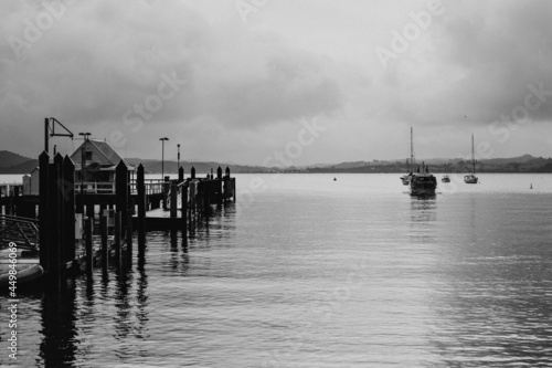 Vintage photo of a small ferry appoaching Russel Wharf on a stormy evening. photo