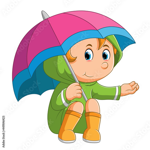 The little girl is sitting under the umbrella and checking the rain