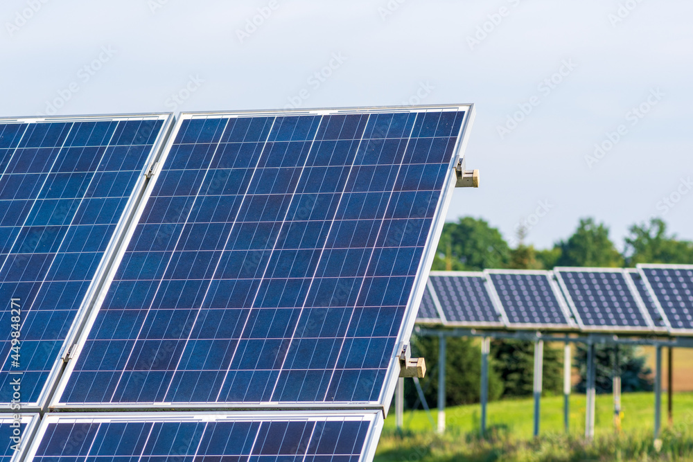 Solar panels in an agriculture green field in the countryside. Solar power plant. Blue solar panels. Alternative source of electricity. Solar farm Solar panels in an agriculture green field in the countryside. Solar power plant. Blue solar panels. Alternative source of electricity. Solar farm