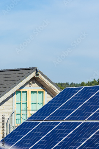 Wallpaper Mural Solar panels on the field in the countryside with house on background. Solar power plant. Blue solar panels. Alternative source of electricity. Solar farm. Vertical Torontodigital.ca