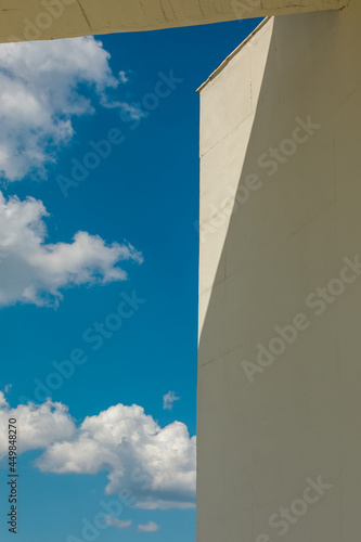 Blue sky with clouds and corner of the wall. Museum of Cosmonautics in Kaluga.