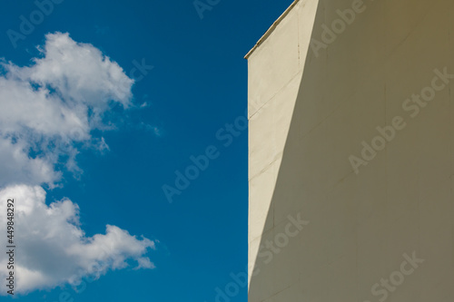Blue sky with clouds and corner of the wall. Museum of Cosmonautics in Kaluga.
