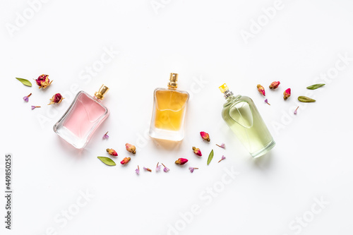 Floral fragrance - perfume bottles with flowers, top view photo