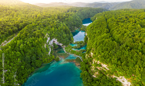 Plitvice, Croatia - Aerial panoramic view of the beautiful Plitvice Lakes (Plitvička jezera) in Plitvice National Park on a bright summer day with rising sun, summer green foliage and turquise water photo