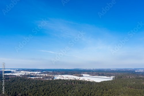 Drone shot flying on winter forest, aerial bird-eye view.