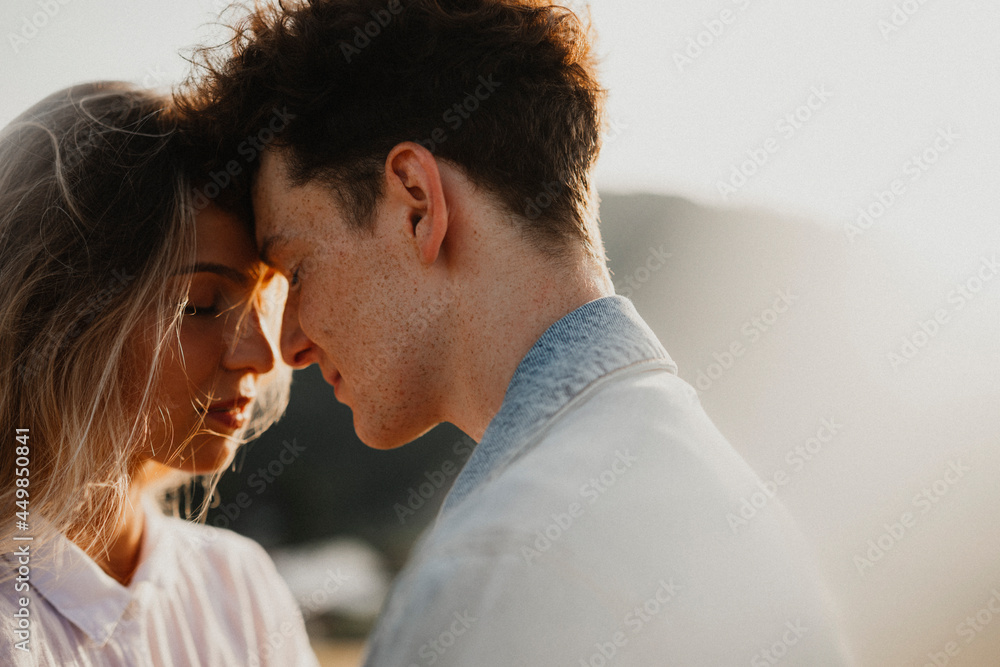 Young couple on a walk in nature at sunset in countryside, hugging. Young couple on a walk in nature at sunset in countryside, hugging.