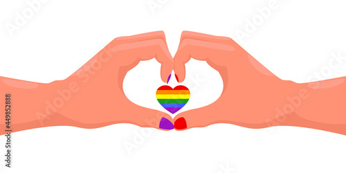 Hands forming a heart with rainbow color. Heart in the color of the rainbow as a symbol of tolerance and LGBT pride.