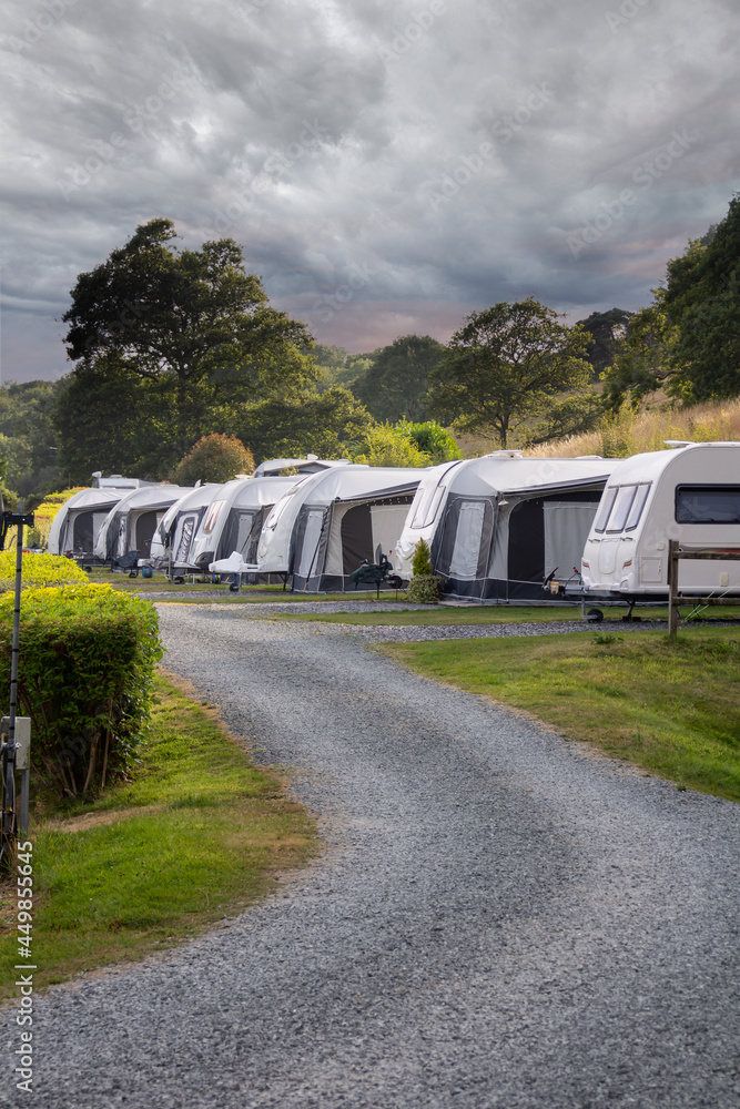 Row of caravans set up for rural break in Wales UK on a stormy summers day. Row of caravans set up for rural break in Wales UK on a stormy summers day.