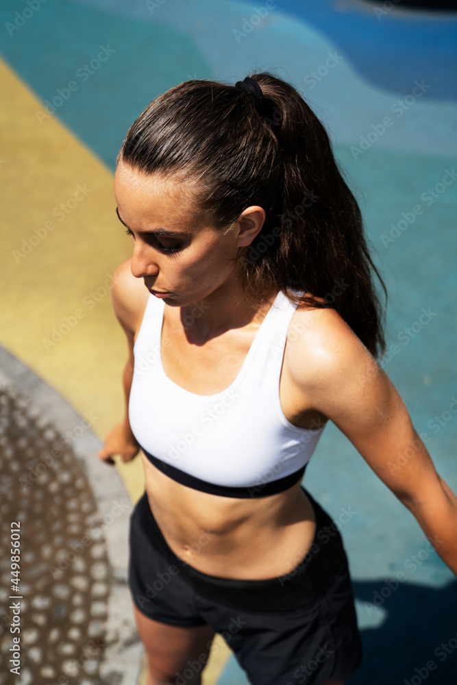 Young fit woman training in the park. Beautiful woman in sportswear working out.