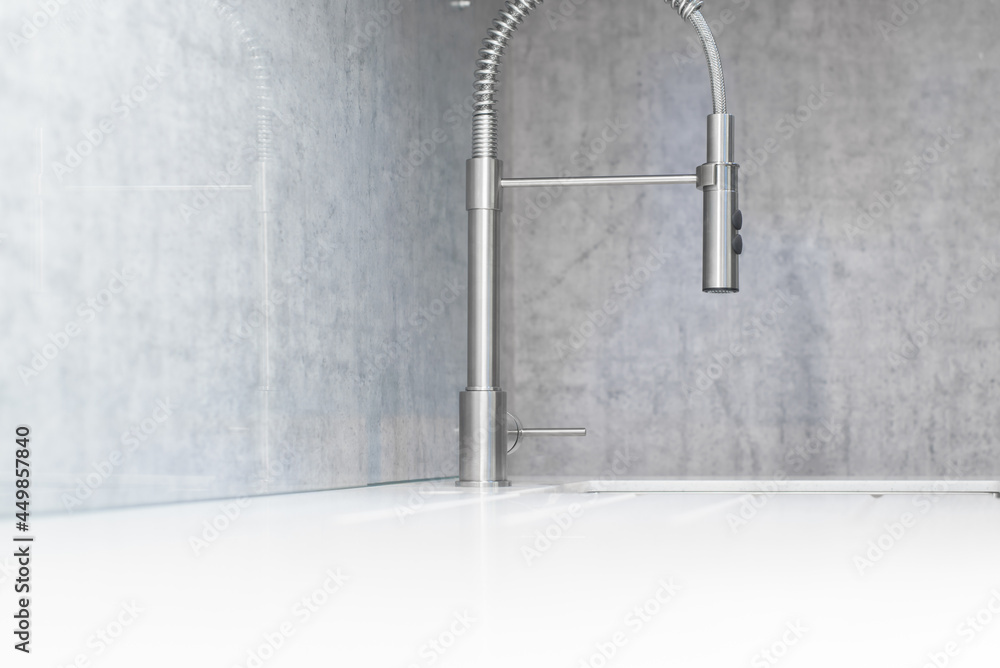Minimalistic modern kitchen interior, faucet and sink side view close-up. Selective focus. Minimalistic modern kitchen interior, faucet and sink side view close-up. Selective focus.