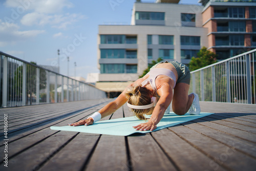 Mid adult woman doing exercise outdoors in city  healthy lifestyle concept.