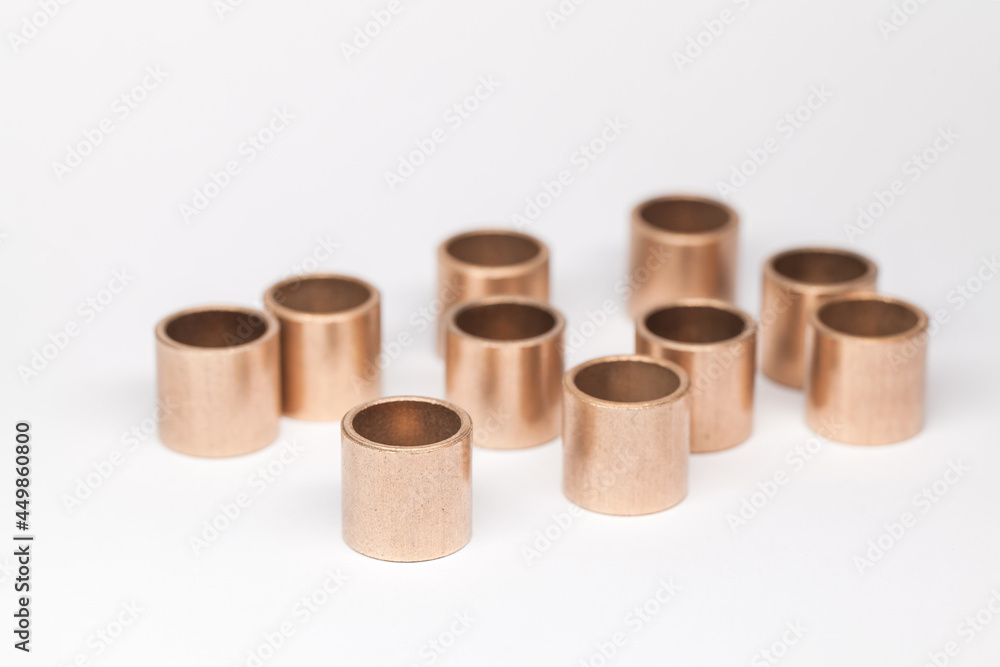 Ten sleeve bronze bearings stand on a white Ten sleeve bronze bearings stand on a white