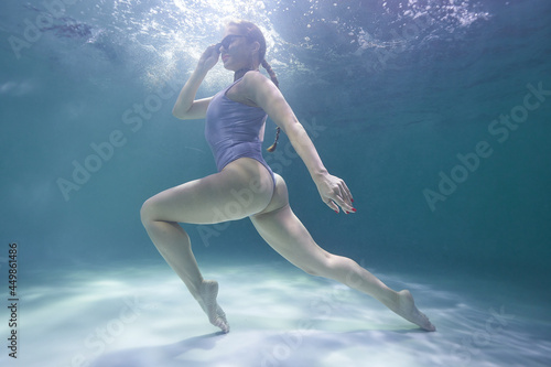 Wallpaper Mural freediver girl dives underwater in the pool in a silver swimsuit and sunglasses on a background of waves Torontodigital.ca