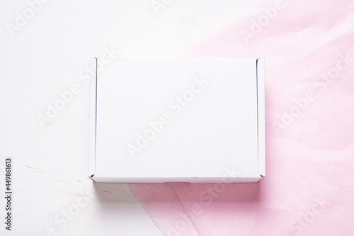 White Cardboard Carton box on pink tissue paper