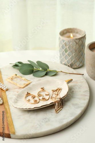 Wallpaper Mural Stylish golden bijouterie and candle on white table Torontodigital.ca