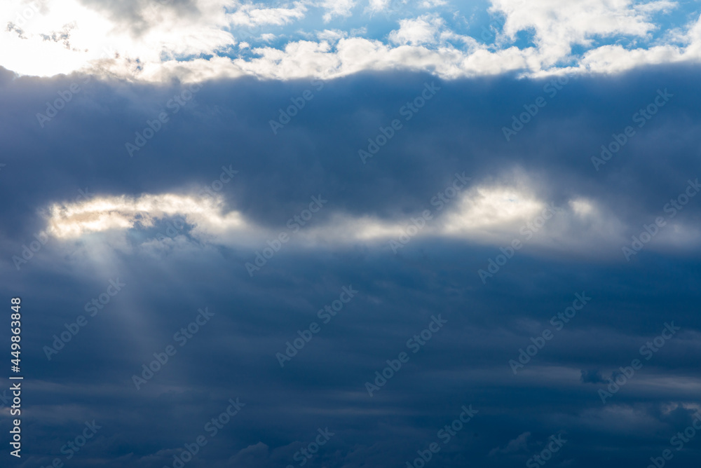Rays of light shining throug dark clouds.Beautiful dramatic sky with sun rays. Rays of light shining throug dark clouds.Beautiful dramatic sky with sun rays.