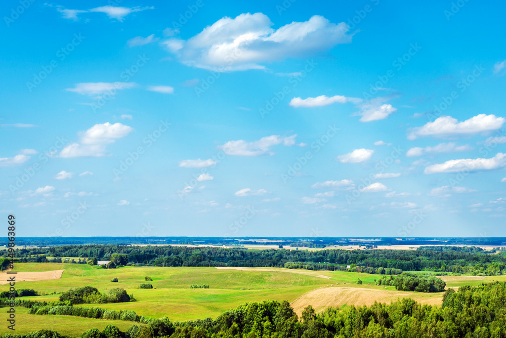 Summer landscape of green forest with bright blue sky,white clouds.Spring cloudscape.Composition of nature.