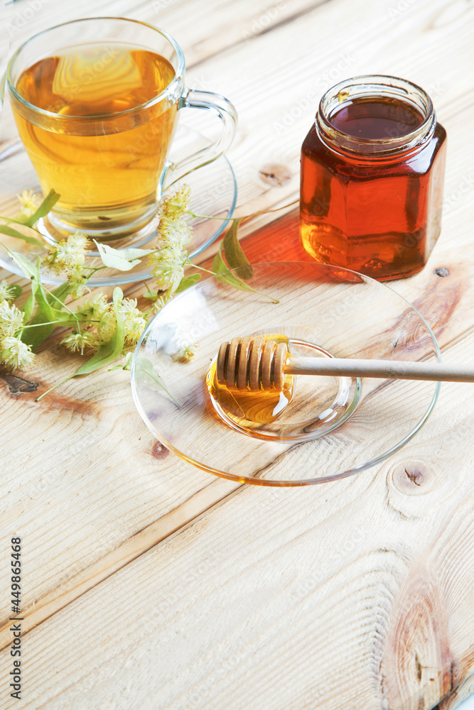 Linden flower tea and linden honey on a light wooden background. The concept of phyto and aromatherapy. Linden flower tea and linden honey on a light wooden background. The concept of phyto and aromatherapy.
