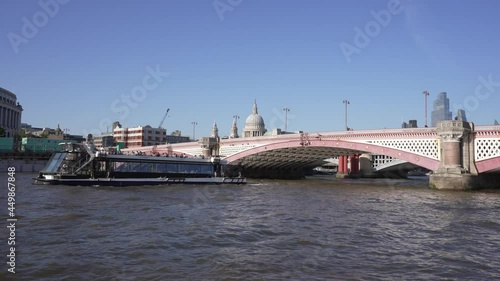 Shot of Blackfriars Bridge from onboard River Thames cruise boat, London photo