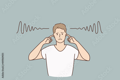 Covering ears and silence concept. Young sad irritated man cartoon character standing covering his ears with fingers with no sounds inside vector illustration 