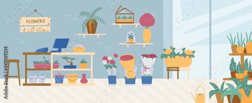 Interior of florist shop with flower bouquets, blossom or green potted plants.
