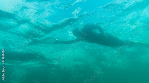 Triathlete swimming in a lake  underwater perspective