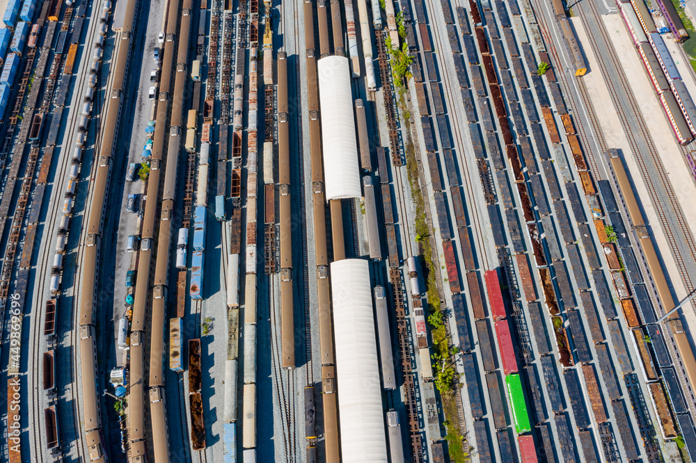 Aerial top view Passenger and freight trains on the railway station for transportation background. wagons with goods on railroad. Aerial top view Passenger and freight trains on the railway station for transportation background. wagons with goods on railroad.