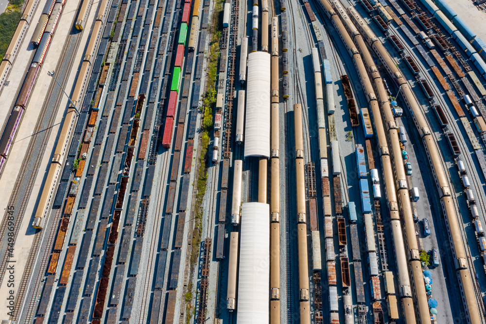 Aerial view of Passenger and railway wagons. Cargo trains. Train container cargo on the railway station for transportation background. wagons with goods on railroad. Aerial view of Passenger and railway wagons. Cargo trains. Train container cargo on the railway station for transportation background. wagons with goods on railroad.