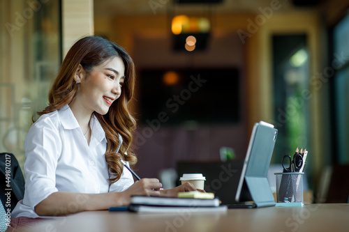 Asian Young Female using laptop computer at office. Student girl working at home. Work or study from home, freelance, business, lifestyle concept.