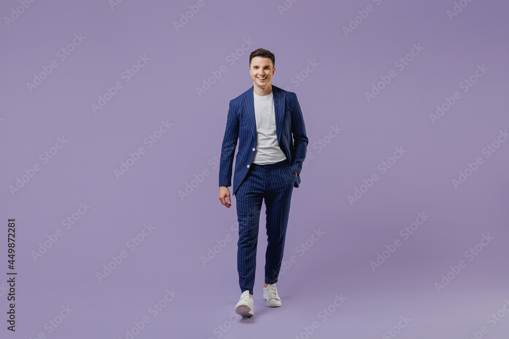 Full size body length happy young successful employee business man lawyer 20s wear formal blue suit white t-shirt work in office move hand in pocket isolated pastel purple background studio portrait Full size body length happy young successful employee business man lawyer 20s wear formal blue suit white t-shirt work in office move hand in pocket isolated pastel purple background studio portrait