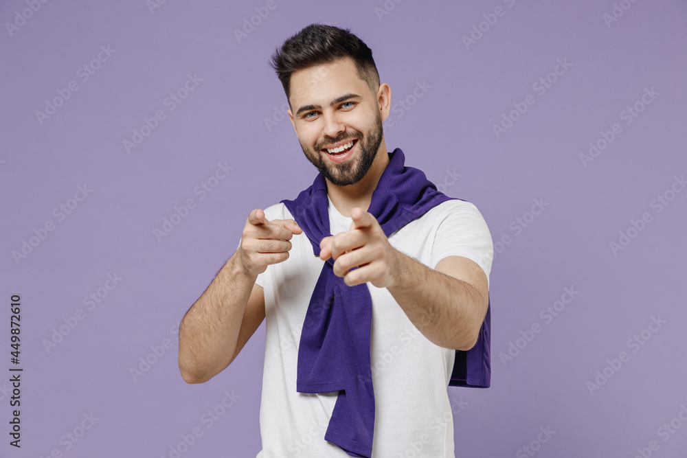 Fun young brunet man 20s wear white t-shirt purple shirt point index fingers camera on you motivating encourage isolated on pastel violet background studio portrait. People emotions lifestyle concept Fun young brunet man 20s wear white t-shirt purple shirt point index fingers camera on you motivating encourage isolated on pastel violet background studio portrait. People emotions lifestyle concept