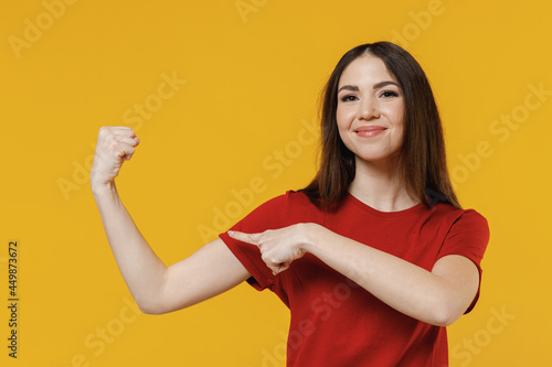 young brunette woman 20s wears basic red t-shirt isolated on yellow background studio portrait. People emotions lifestyle concept