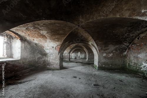 Abandoned ancient catacombs  artillery warehouses  barracks of the coastal  naval  defensive fort of the 18th and 19th centuries  beautiful vaulted  arched  ceilings  side dense light from window.
