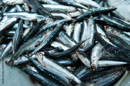 Fresh fish displayed in a traditional food market, a pile of anchovies.