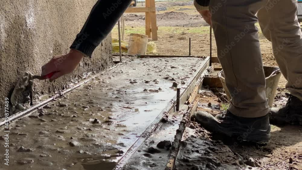 Construction worker spreading cement. Construction worker spreading cement.