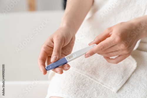 Positive negative pregnancy test result. Abortion, adoption, invitro fertilization concept. Woman holding pregnancy test. Maternity, motherhood concept