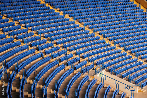 Blue empty seats at the stadium. © vitleo
