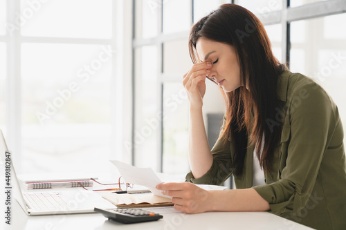 Vászonkép Young tired stressed overworked businesswoman freelancer teacher student exhausted after hard work, suffering from migraine headache at office