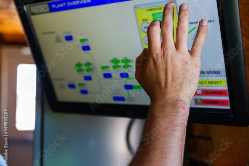 A technician makes an adjustment on a touch screen