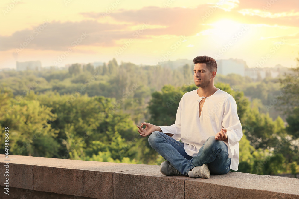Man meditating outdoors on summer day. Space for text Man meditating outdoors on summer day. Space for text