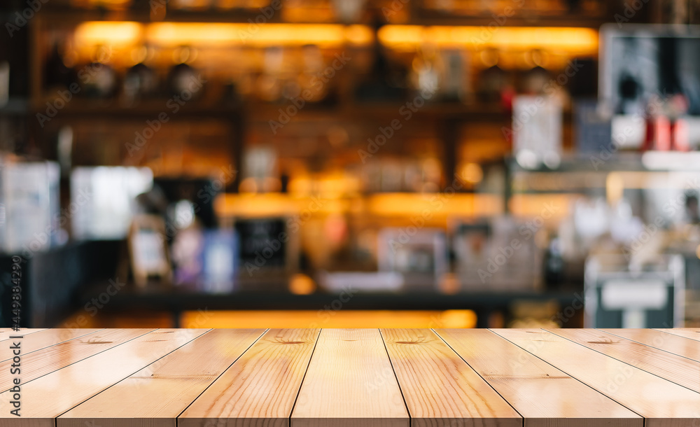 Empty wooden table top on blur restaurant background.	