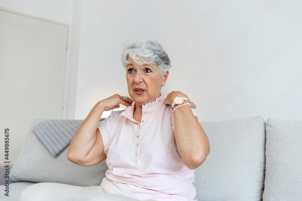 Woman with shoulder pain. Woman grimaces at the pain in her shoulders. Upset senior lady feel sudden shoulder pain, muscles ache tension injury. Grandma touching shoulder have osteoarthritis arthritis Woman with shoulder pain. Woman grimaces at the pain in her shoulders. Upset senior lady feel sudden shoulder pain, muscles ache tension injury. Grandma touching shoulder have osteoarthritis arthritis