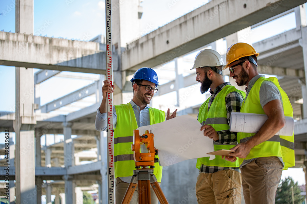 Business building teamwork people concept. Group of engineer with blueprint on construction site Business building teamwork people concept. Group of engineer with blueprint on construction site