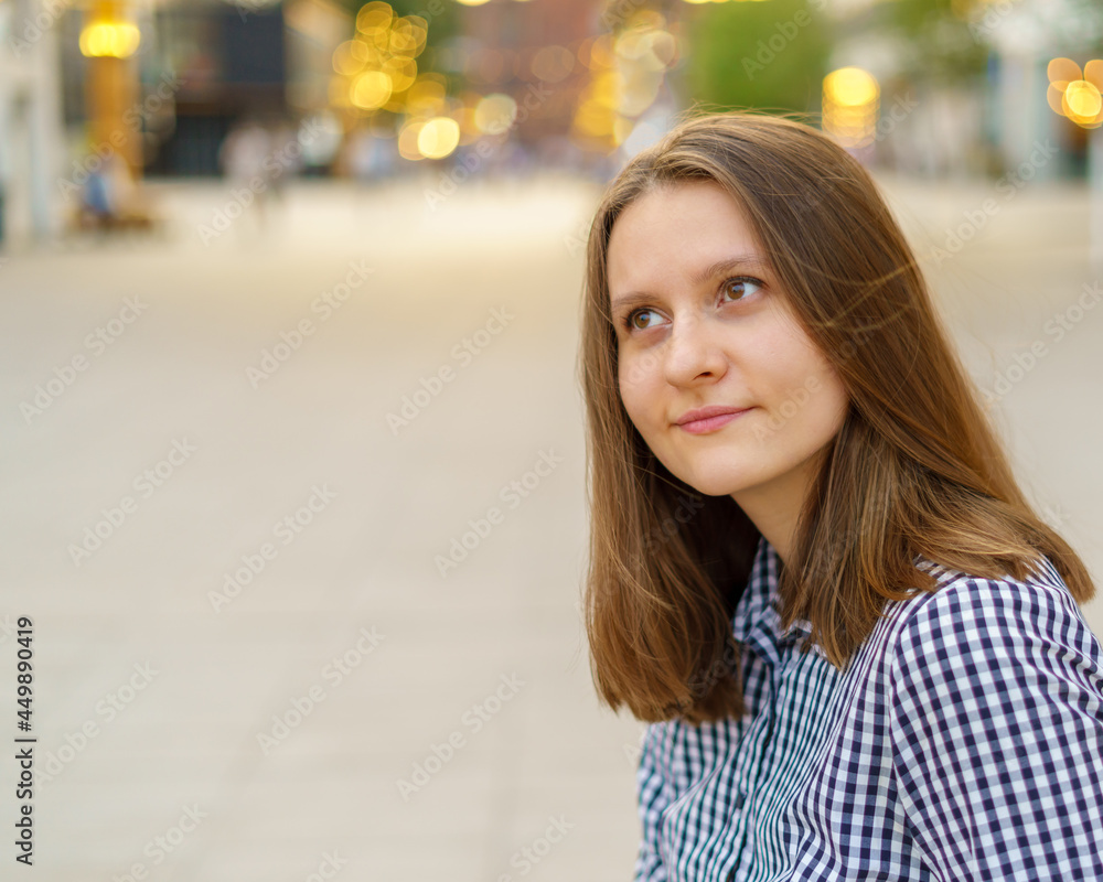 Close-up portrait of beautiful young woman with long blonde hair looking away against background of city view, enjoying summer and rest. Copy space Close-up portrait of beautiful young woman with long blonde hair looking away against background of city view, enjoying summer and rest. Copy space