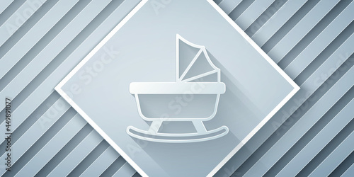 Paper cut Baby stroller icon isolated on grey background. Baby carriage, buggy, pram, stroller, wheel. Paper art style. Vector