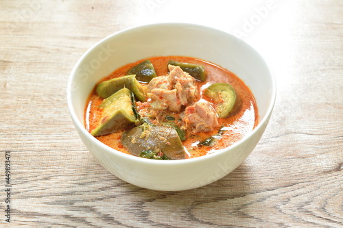 spicy boiled chicken with slice long eggplant in coconut milk green curry soup on bowl