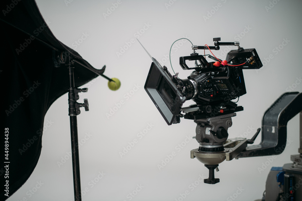 Professional cinema and video camera on the set. Shooting shift, lighting fixtures, shooting equipment and the team.